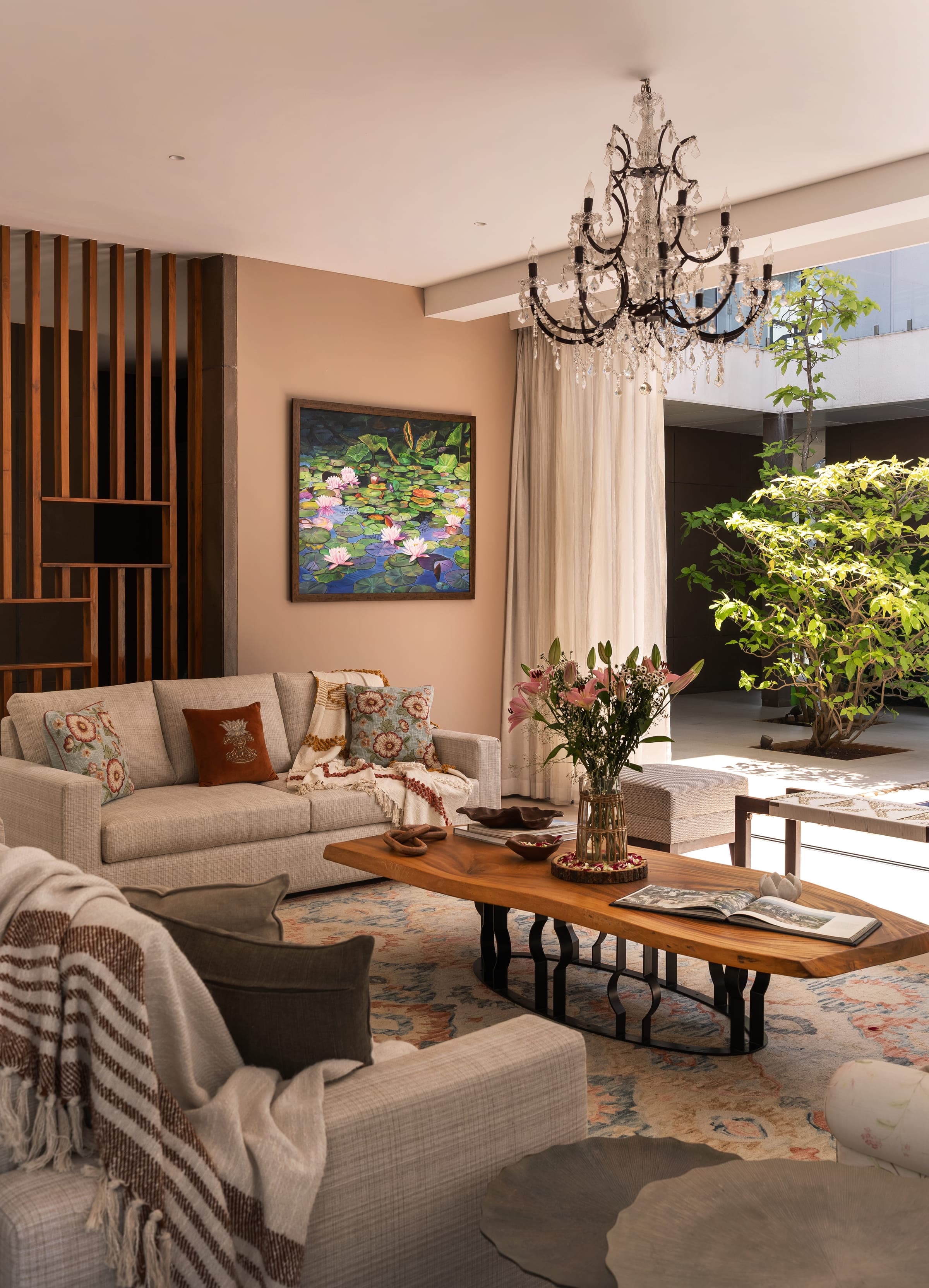 A living and dining space by Azmin Kaka Interiors, layered in linen, timber and stone.